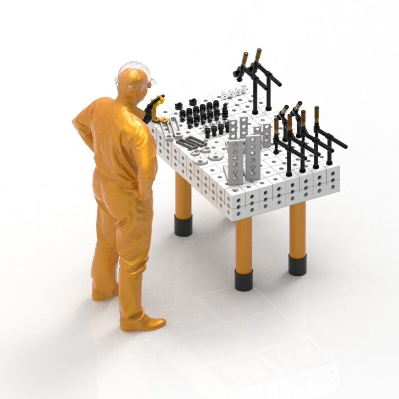 nr.1 stół spawalniczy cubeweld ltimate 28 1200x800mm + pakiet narzędzi 1 Robotnik przy stole spawalniczym z narzędziami.